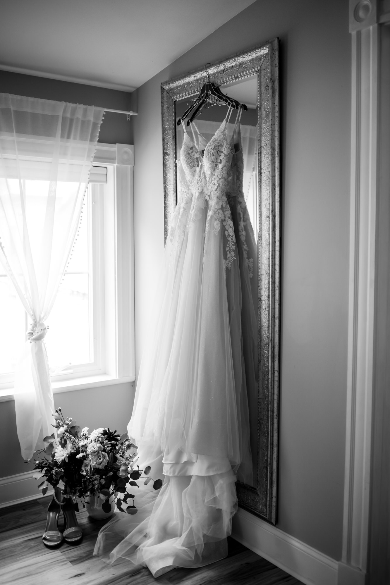 a wedding dress on a mirror at Meadow Ridge Farm a luxury rustic barn wedding venue in Maine