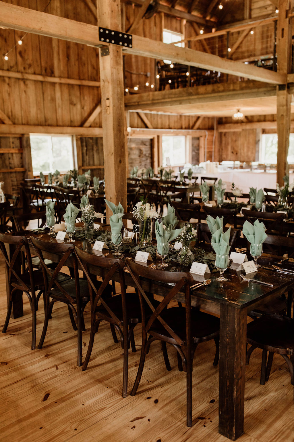 a table set for a wedding reception at Meadow Ridge Farm a luxury rustic maine barn wedding venue