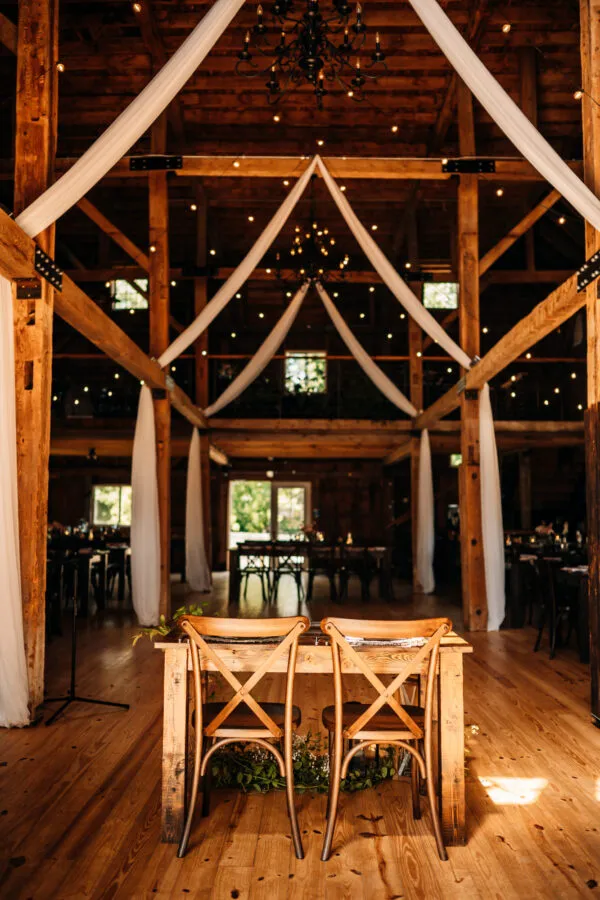 a table set for a wedding reception at Meadow Ridge Farm a luxury rustic maine barn wedding venue